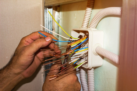67615853 - electricians clears the ends of the wires. installation works